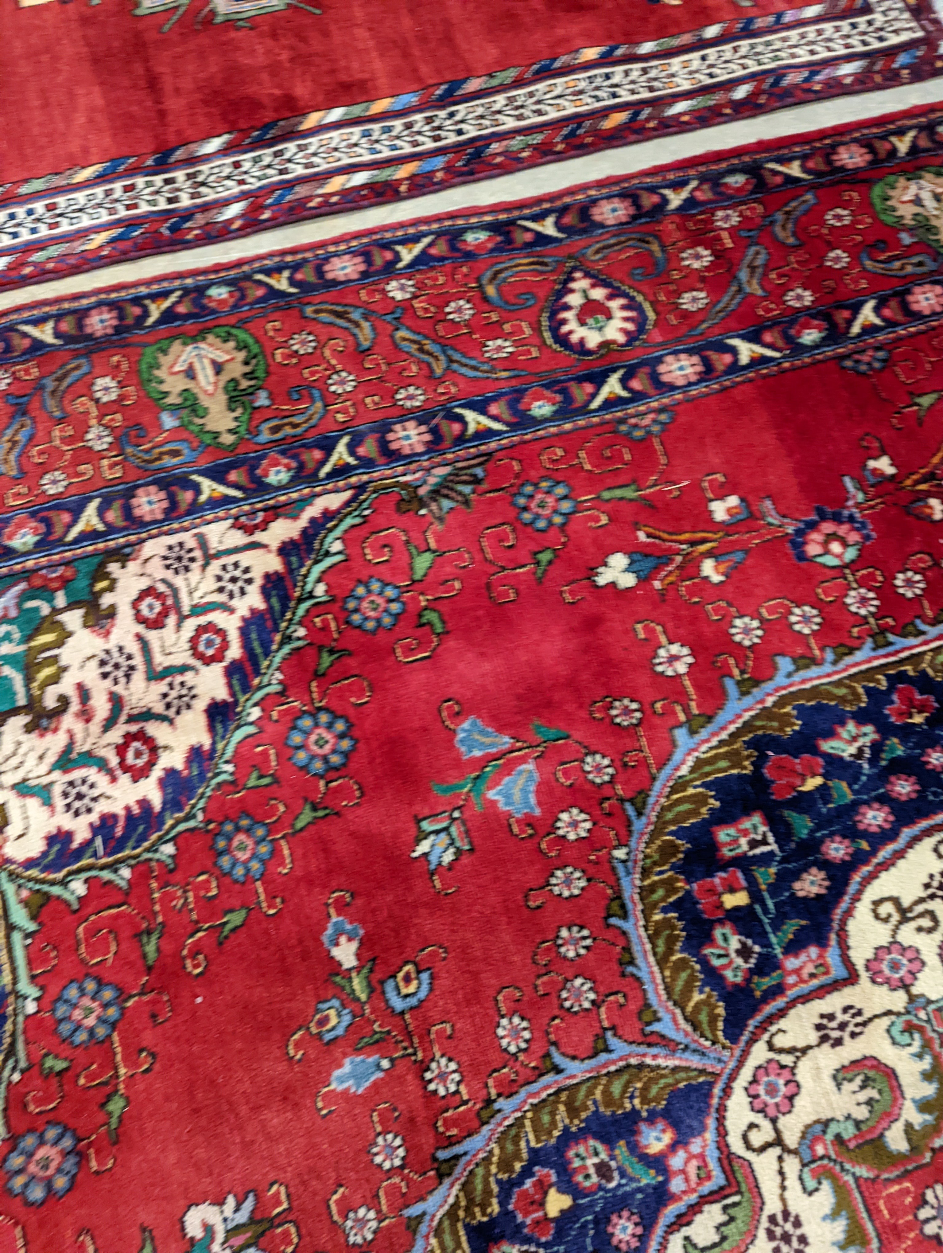 A Tabriz red ground carpet, 380 x 300cm